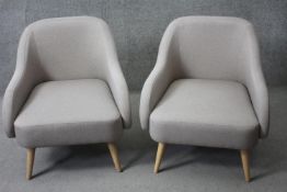 A pair of contemporary vintage style tub armchairs.