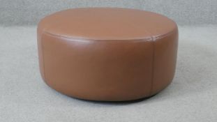 A contemporary leather upholstered Camerich Puck stool. H.20 Diam.65cm
