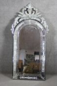A Venetian style pier mirror with arched plate in etched glass frame and cresting. H.143 W.73 cm.