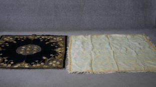 Two Oriental textile embroidered throws. A Turkish silvered thread foliate design throw with