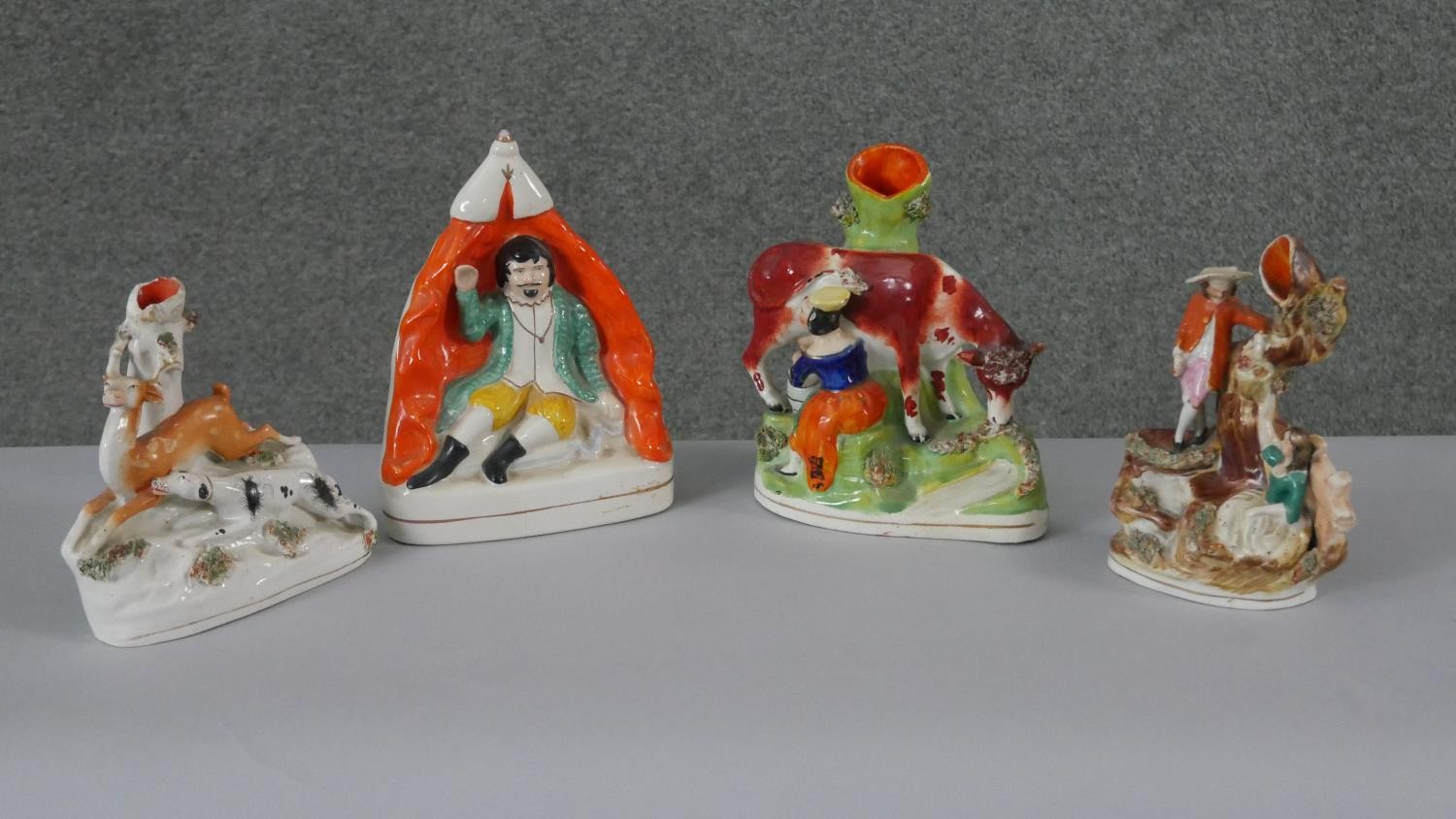 A collection of 19th century Staffordshire pottery figures. Including three spill vases, one with