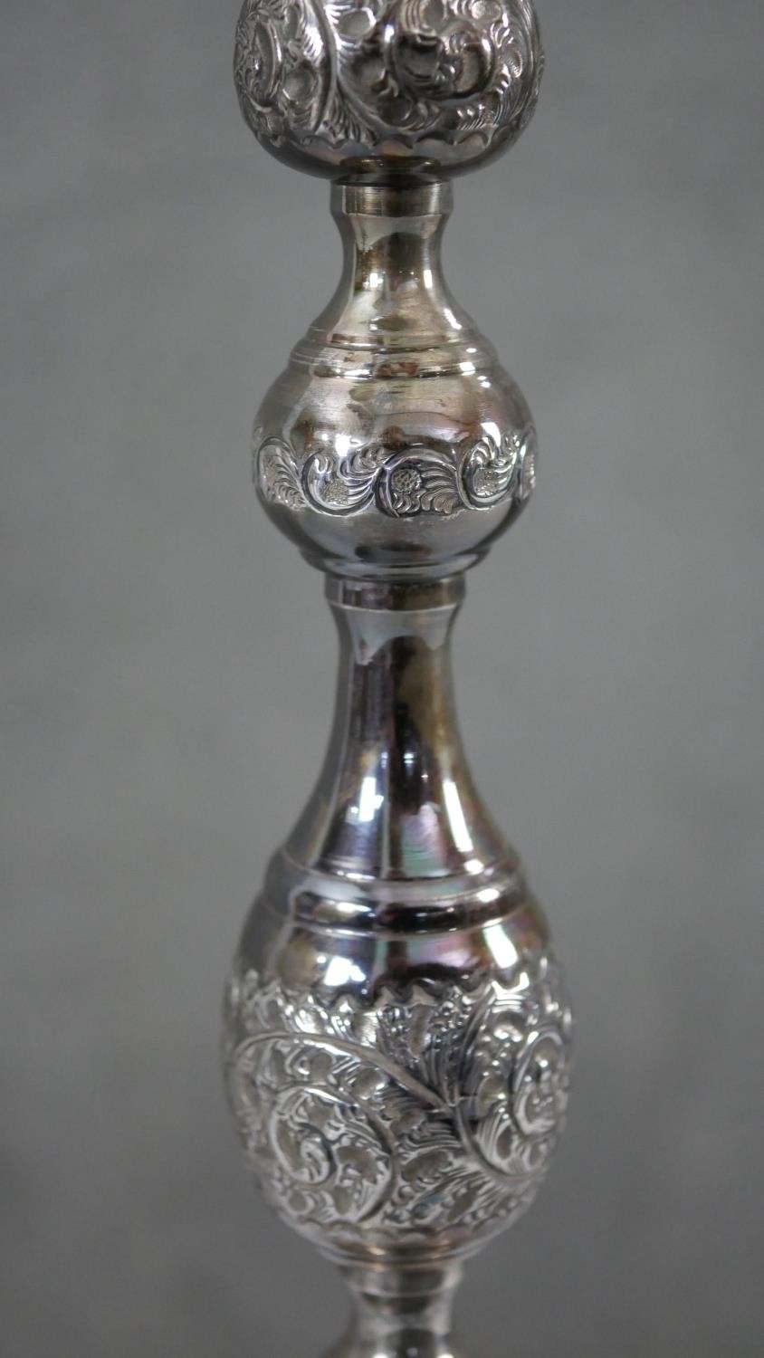 A pair of 1920'a repousse silver candlesticks with scrolling foliate design on scalloped bases. - Image 7 of 8