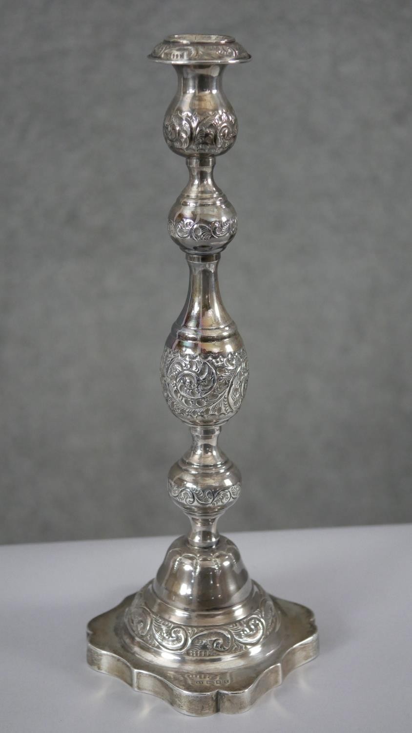 A pair of 1920'a repousse silver candlesticks with scrolling foliate design on scalloped bases. - Image 3 of 8