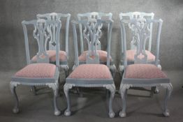A set of six painted Chippendale style dining chairs with carved and pierced splat backs above