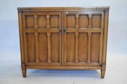 A contemporary walnut buffet cabinet with fold out flap top. H.75 W.92 D.46cm