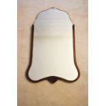 A mid century shaped plate Art Deco style wall mirror in carved oak frame. H.70 W.43cm
