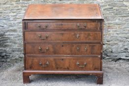 A Georgian figured mahogany bureau with fall front enclosing fitted interior above four long