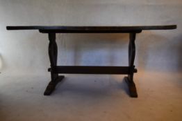 A mid century oak country antique style dining table on shaped stretchered supports. H.75 W.156 D.