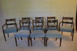 A set of eight late Georgian mahogany bar back dining chairs with carved splats above stuffover