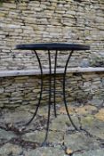 A metal framed garden table with mosaic inlaid top. H.70 W.46cm