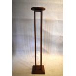 A teak Glasgow School inspired torchere. H.123 W.24cm