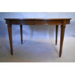 A walnut extending dining table with three extra leaves raised on square tapering supports. H.73 W.