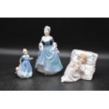 A collection of three ceramic lady figurines, a young girl and young lady in dresses and a girl