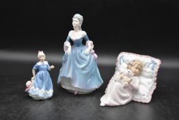 A collection of three ceramic lady figurines, a young girl and young lady in dresses and a girl