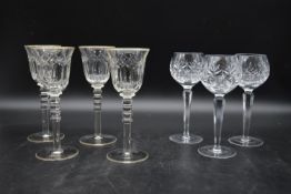 A set of four 20th century baluster cut crystal wine glasses, with gilded detail on the lip and