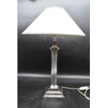 A 20th century silver plated Corinthian column style table lamp with cream shade. H.47cm (lamp) (