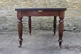 An early 19th century style mahogany dining table with two extra leaves on tapering reeded