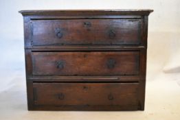 A 17th century country oak chest. H.76 W.98 D.62cm (small section missing to the top as