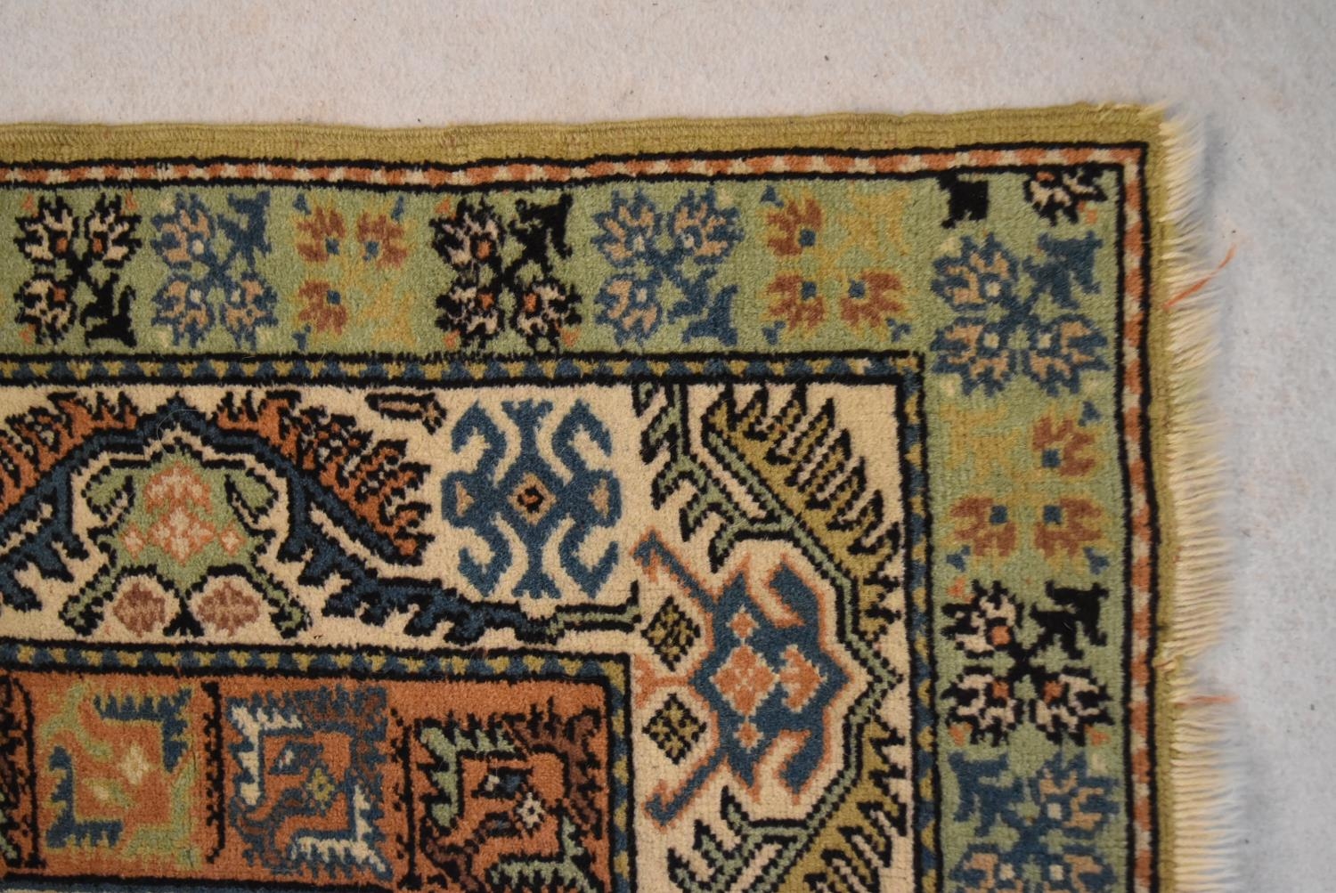 An Eastern rug with central hexagonal medallion in stylised multiple borders. L.234 W.134cm - Image 2 of 4