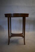 An Edwardian mahogany and satinwood work table with hinged top revealing fitted interior on swept