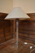 A 20th century silver plated Corinthian column style table lamp with sage green shade. H.69 W.