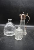 An late 19th century claret jug with silver plated lid and a cut crystal jar with lid along with a