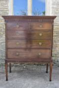 A 19th century mahogany chest on stand with dentil carved cornice above two short and three long