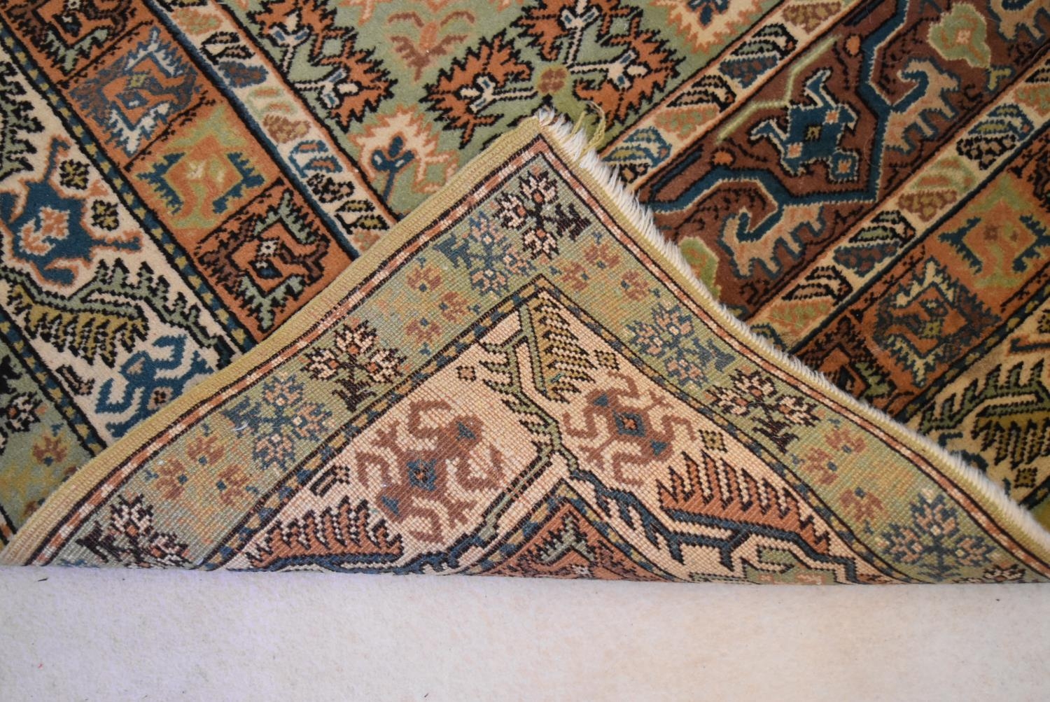 An Eastern rug with central hexagonal medallion in stylised multiple borders. L.234 W.134cm - Image 3 of 4