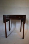 A Georgian mahogany drop flap table fitted with frieze drawer on square chamfered supports. H.68 W.