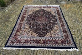 An Indian Jaipur carpet with floral central medallion on midnight ground within naturalistic