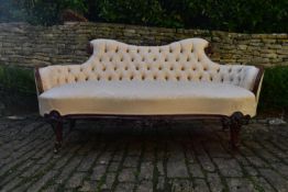 A Victorian carved rosewood frame sofa in deep buttoned damask upholstery on cabriole supports. H.89