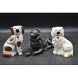 Two Staffordshire dogs and a black painted spelter lion. H.14 W.20cm