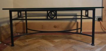 A metal framed coffee table with plate glass top. H.40 W.100 D.60cm