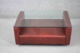 A mid century vintage leather faced coffee table with plate glass top. H.36 W.86 D.66 cm.