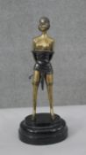 An Art Deco style patinated brass figure of 'The Whip Girl' after Bruno Zach. H.32 W.14 D.12cm