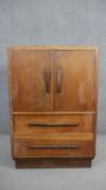 A mid century light oak Art Deco style tallboy cabinet. H.113 W.76 D.46cm