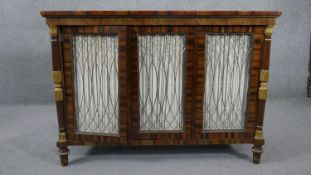 A Regency style rosewood and crossbanded chiffonier with grille panelled doors flanked by gilt