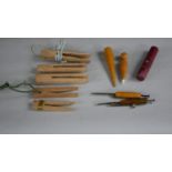 A collection of 19th century sewing items. Including wooden wool pegs, a fabric marker and other