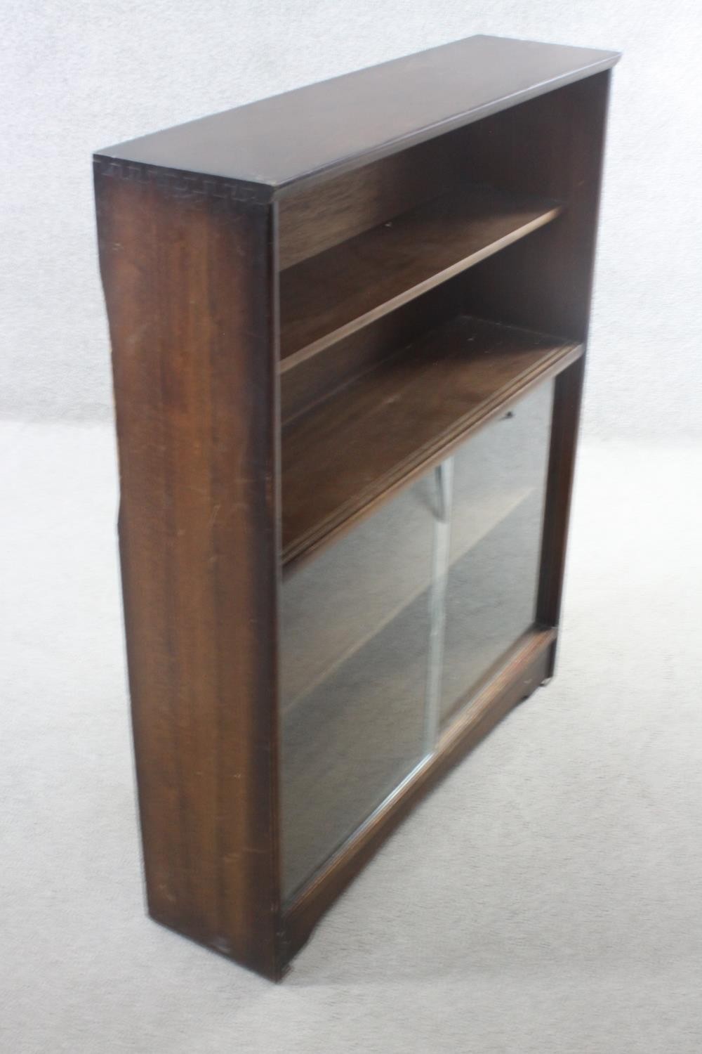 A vintage teak bookcase with open shelves above sliding plate glass doors. H.113 W.91 D.25 cm. - Image 4 of 5