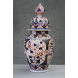 A Japanese Meji period Imari lidded jar with chrysanthemum design. H.43 W.7cm.