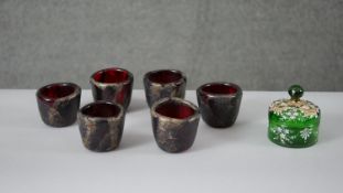 A collection of coloured glass. Including a set of six Manna gold foil ruby art glass cups, signed