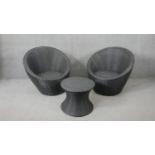 A pair of contemporary woven garden or conservatory tub seats and a matching low table.