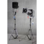 A pair of theatre follow spot lights on adjustable tripod bases. H.143 W.73cm.