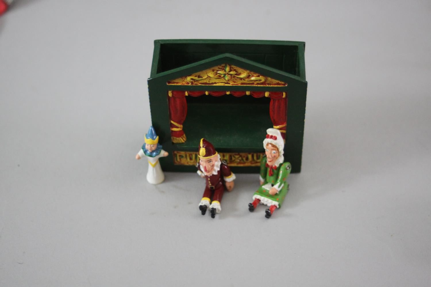 A miniature painted die cast Punch and Judy theatre with three articulated dolls along with two - Image 5 of 6