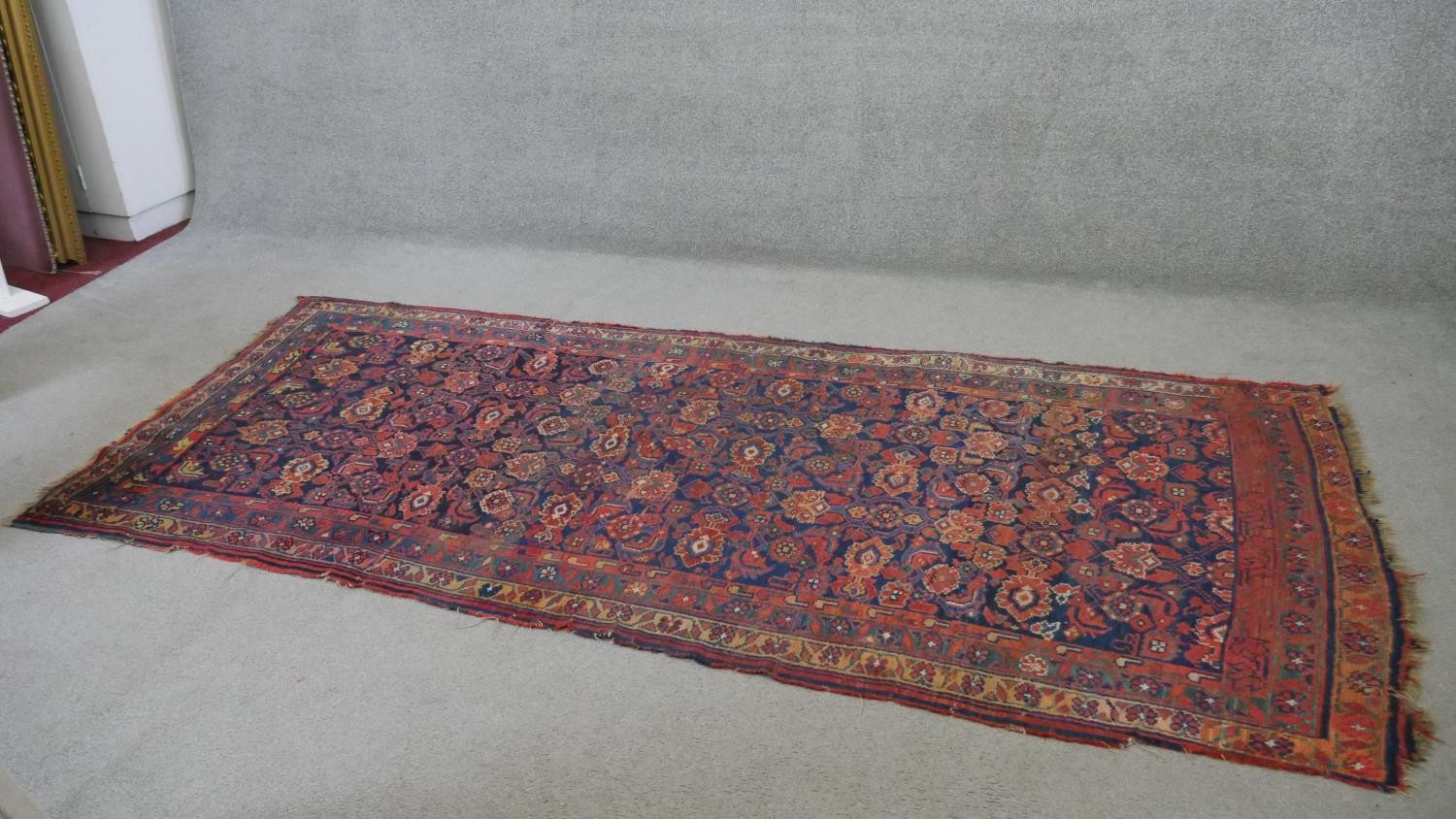 A Persian Mahal carpet with allover floral decoration on a midnight blue ground contained within