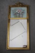 A gilt framed wall mirror with printed glazed panel with a vase of flowers. H.74 W.33cm