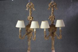 A large pair of carved twin branch wall lights with shell, flowerhead and ribbon decoration. h.85