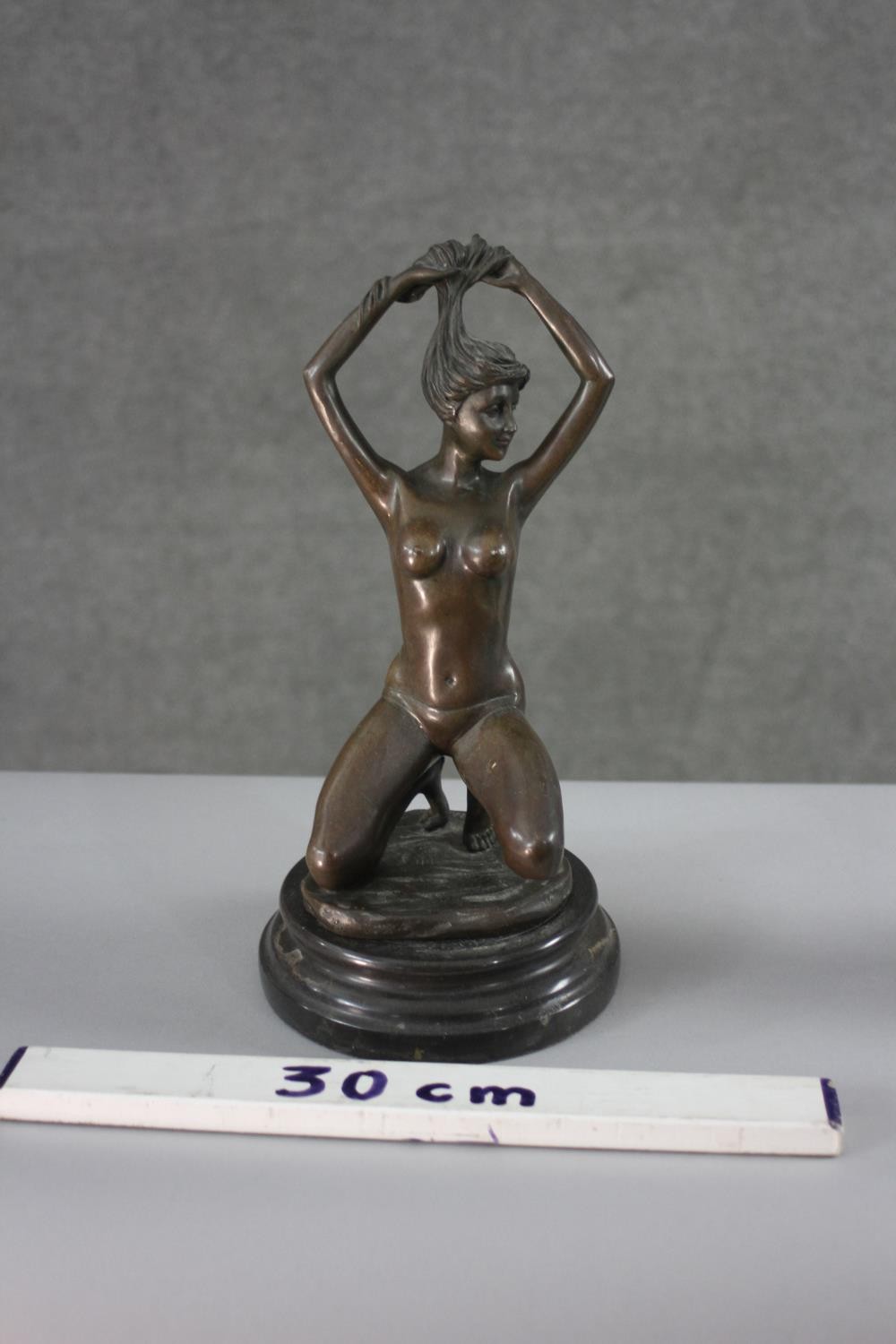 An erotic spelter figure of a kneeling nude woman holding up her hair. H.30 W.16 cm. - Image 3 of 3