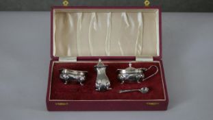 A red leather cased silver cruet set. Hallmarked IF & Son for Israel Freeman & Son Ltd, London,1962.