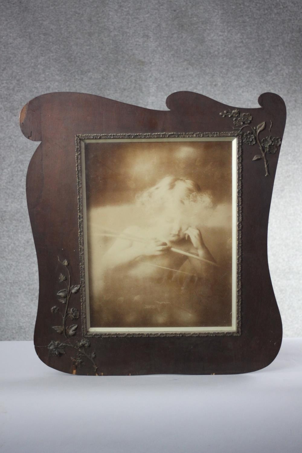 A 19th century veneered and plaster applique floral design picture frame with black and white